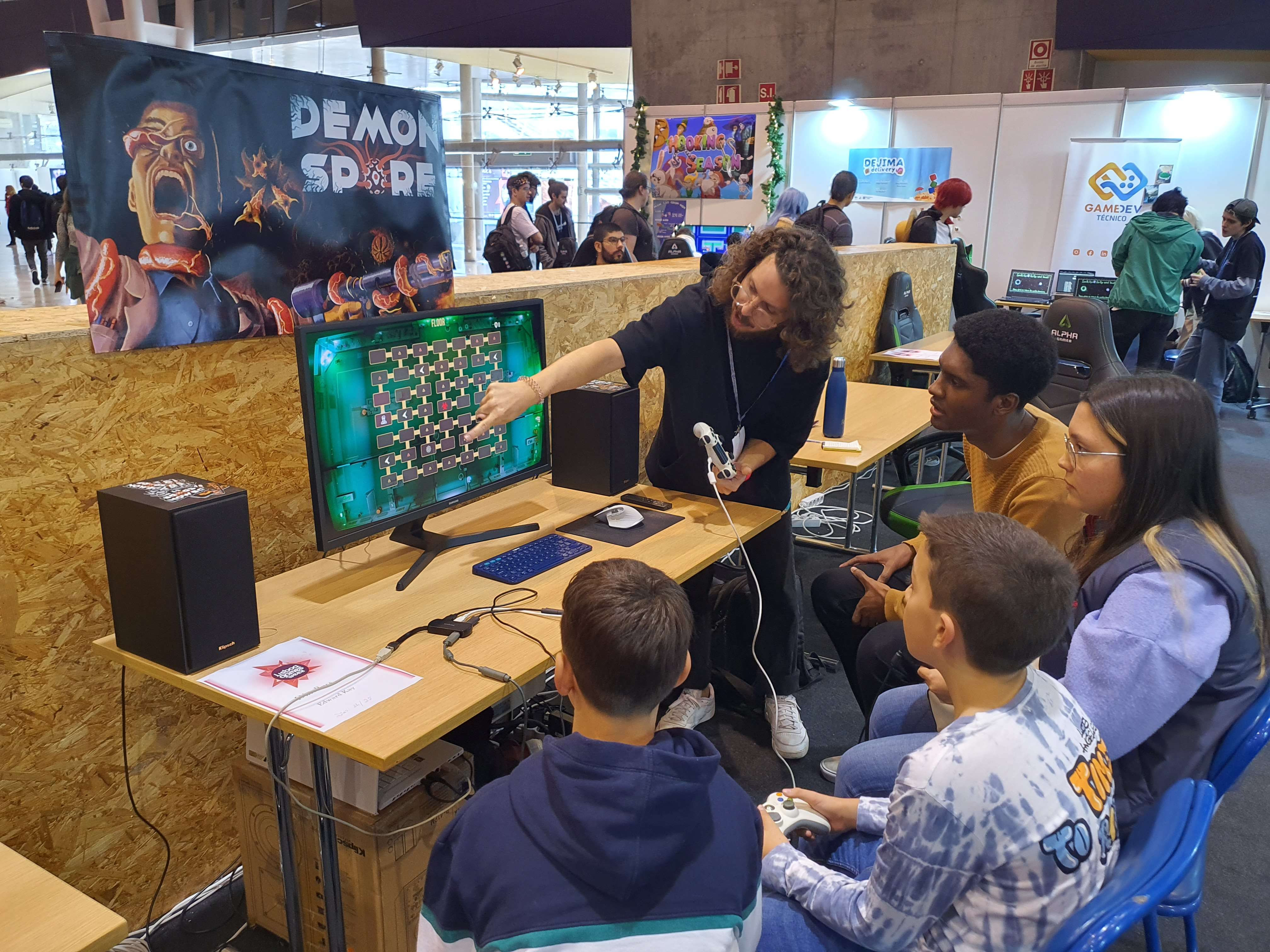 Children playing Demon Spore around a computer.
